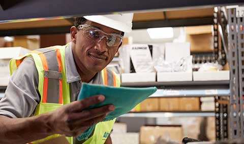 An Airgas Supply Chain technician reviews an order form.
