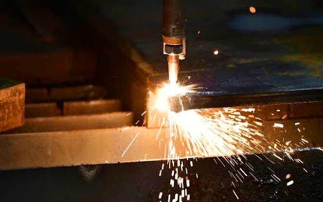 Cutting torch cutting a steel sheet