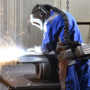 Worker welding in full safety gear