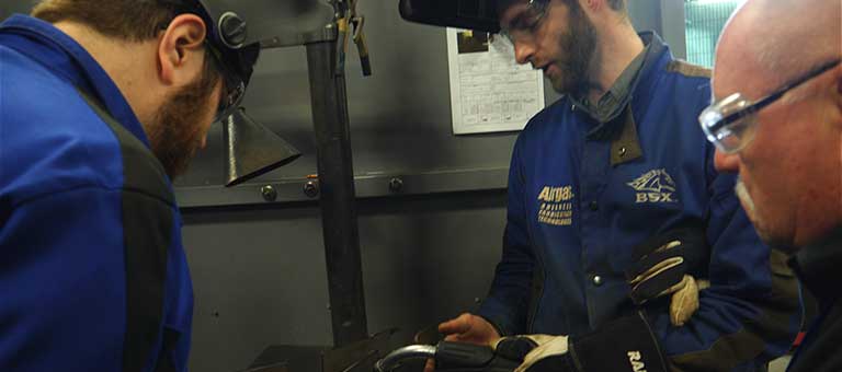 A student learning to TIG weld