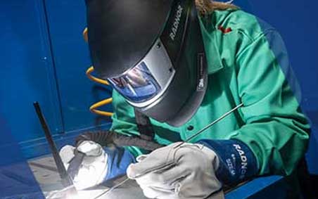 A welder in RADNOR PPE, TIG welding